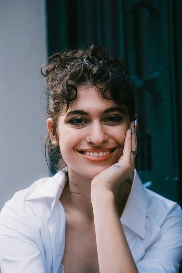 A woman with a nose ring smiling