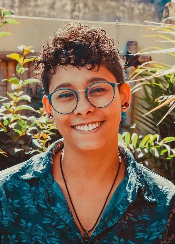 a woman smiling with glasses