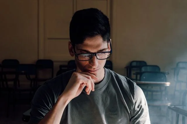 A man thinking in a classroom