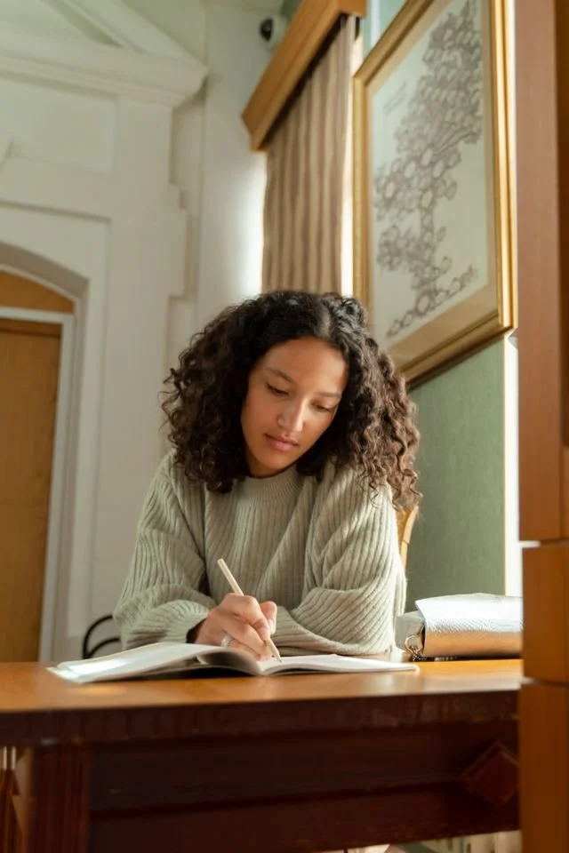 a girl writing in her notebook