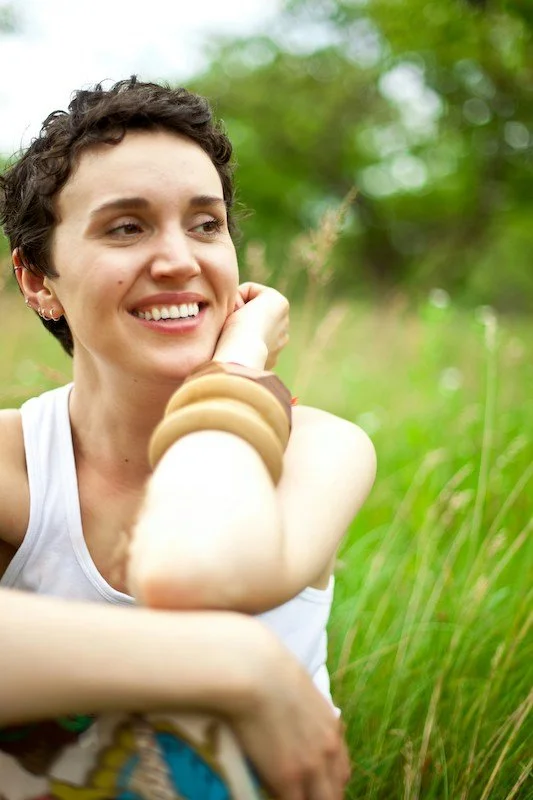 a woman smiling outdoors