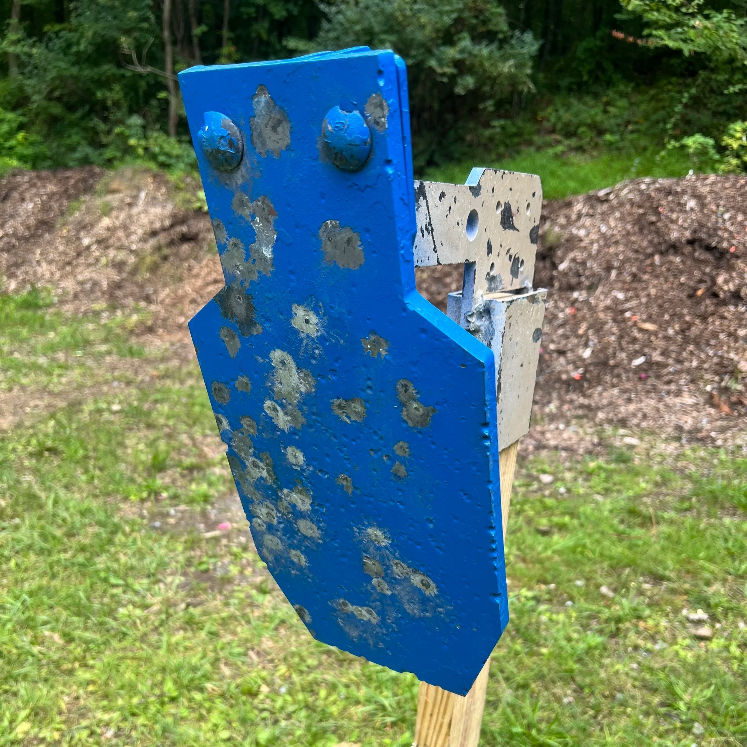 Reduced C-zone Mini-ADAP steel plate painted blue used for visual and audible feedback in dynamic and tactical pistol shooting drills.