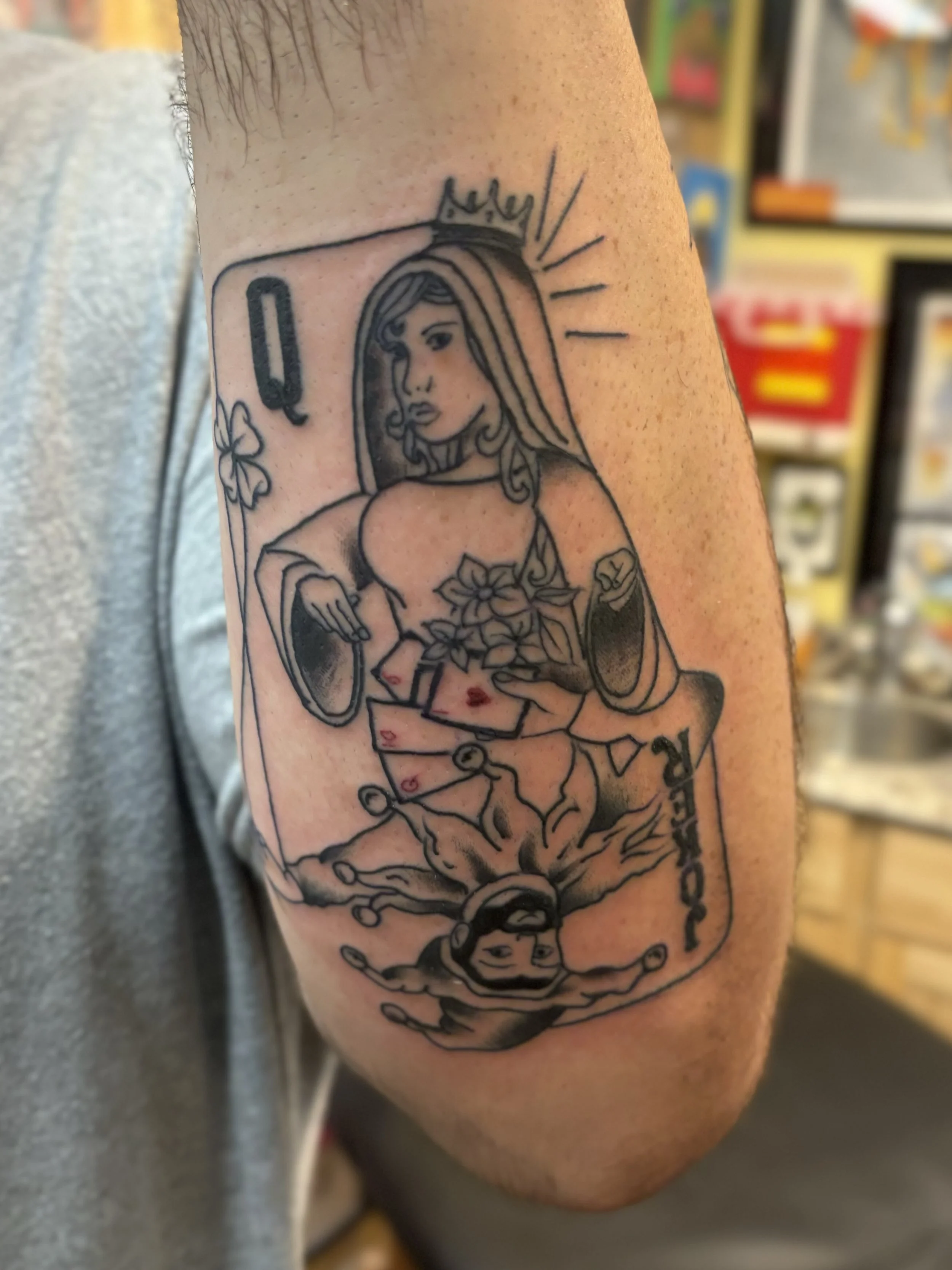 Tattoo of a woman with long hair, wearing a crown, surrounded by flowers, and with a clock design below.