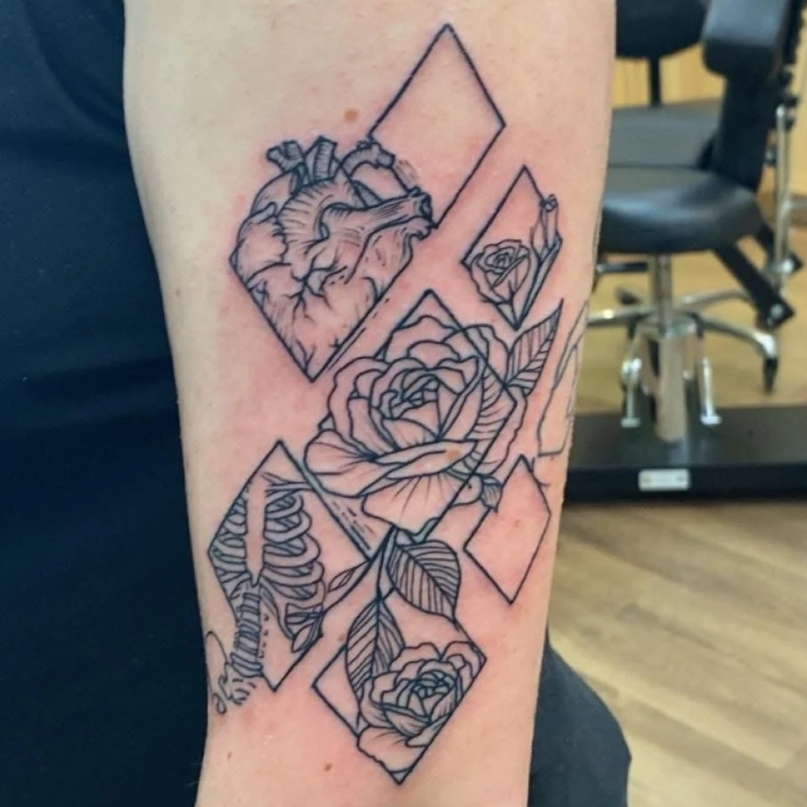 Line art tattoo of roses, leaves, a heart, and a skeleton, surrounded by rectangular frames.