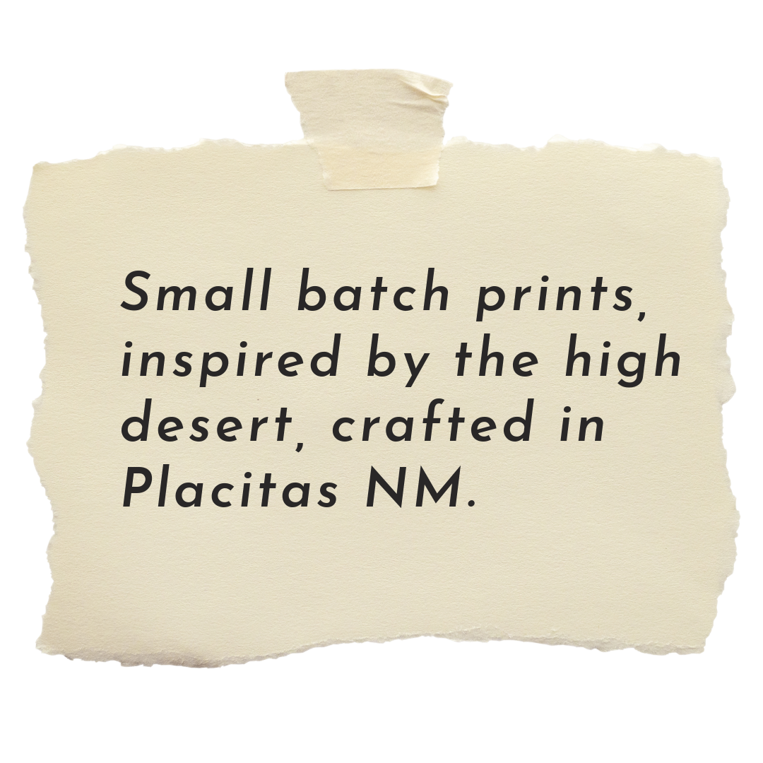 Note with torn edges taped to a surface that reads, "Small batch prints, inspired by the high desert, crafted in Placitas NM."