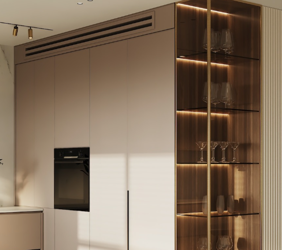 Modern kitchen with built-in oven and glass display cabinet filled with glassware, illuminated by warm lighting.