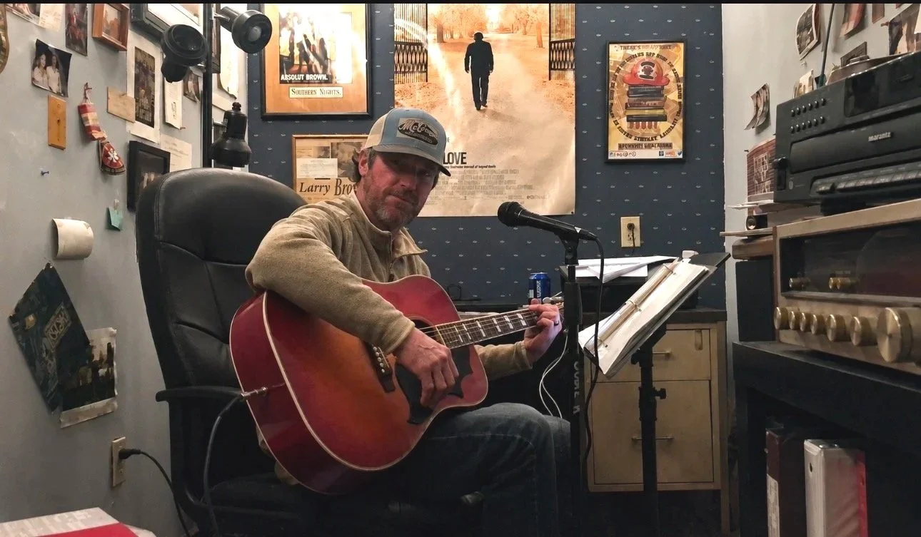 Shane Brown playing guitar in "the cool pad", the same room his dad, Larry, wrote all his award-winning books