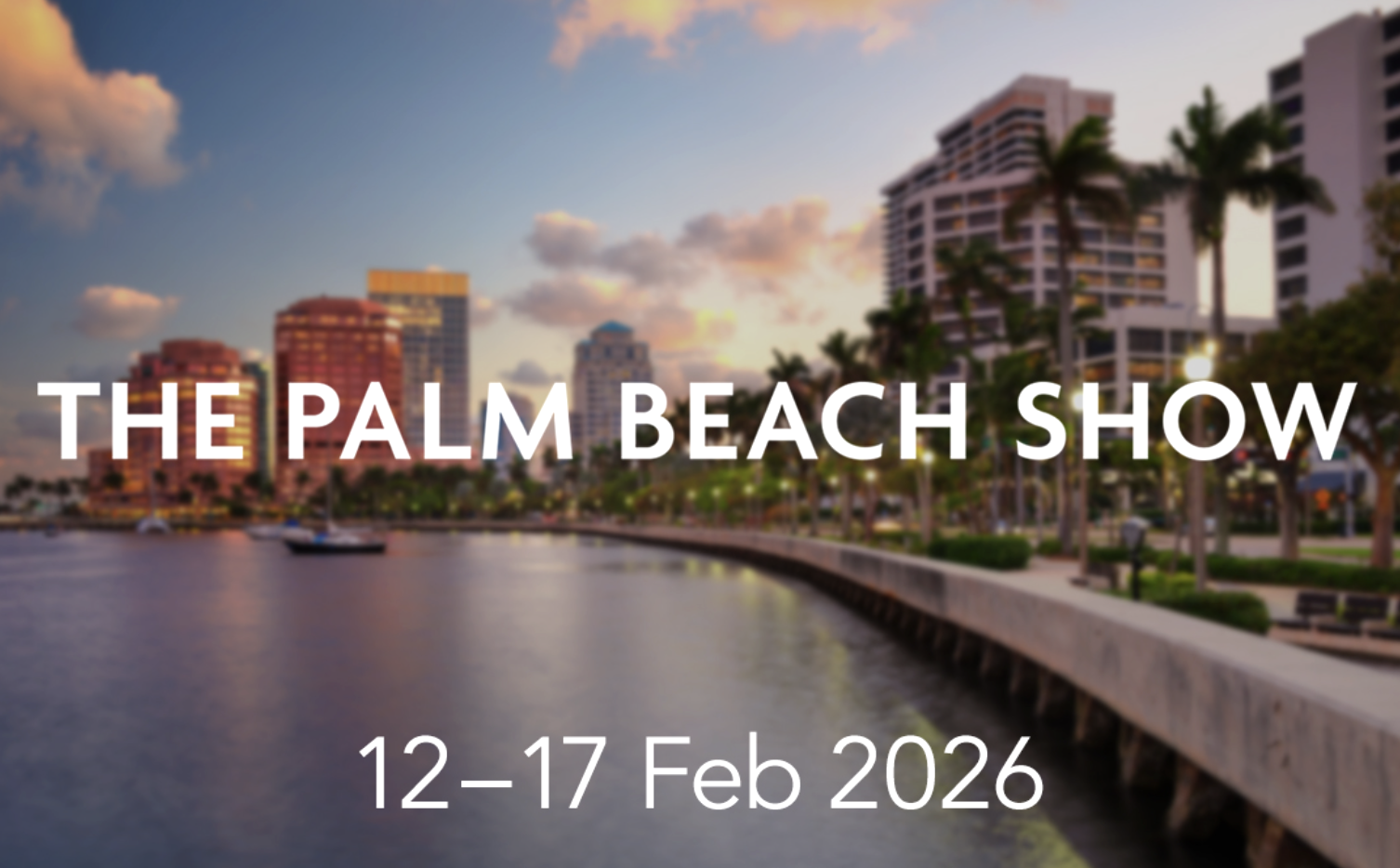 A waterfront cityscape during sunset with tall modern buildings, palm trees, and a promenade along the water, promoting The Palm Beach Show from February 12 to 17, 2026.