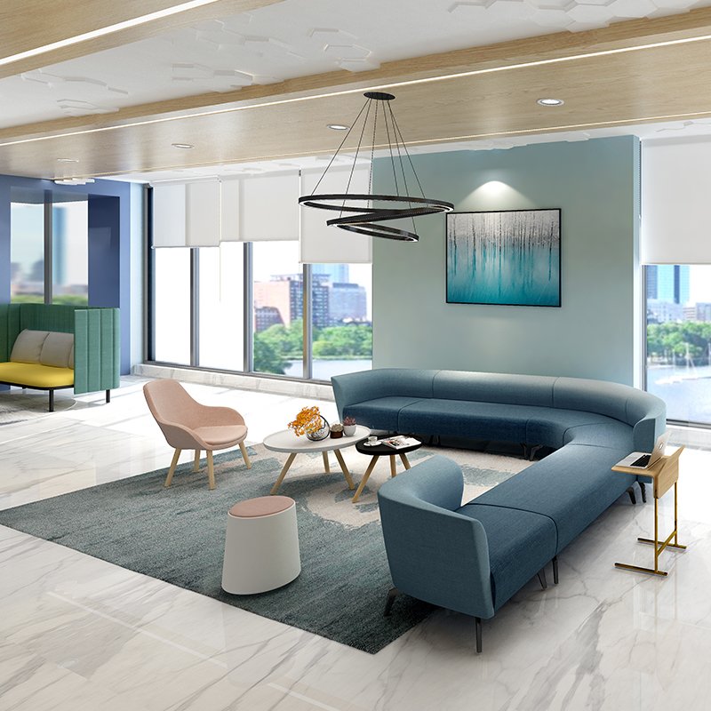 Modern living room with a U-shaped blue sofa, pink armchair, white coffee table, and large windows overlooking a cityscape with water and trees.