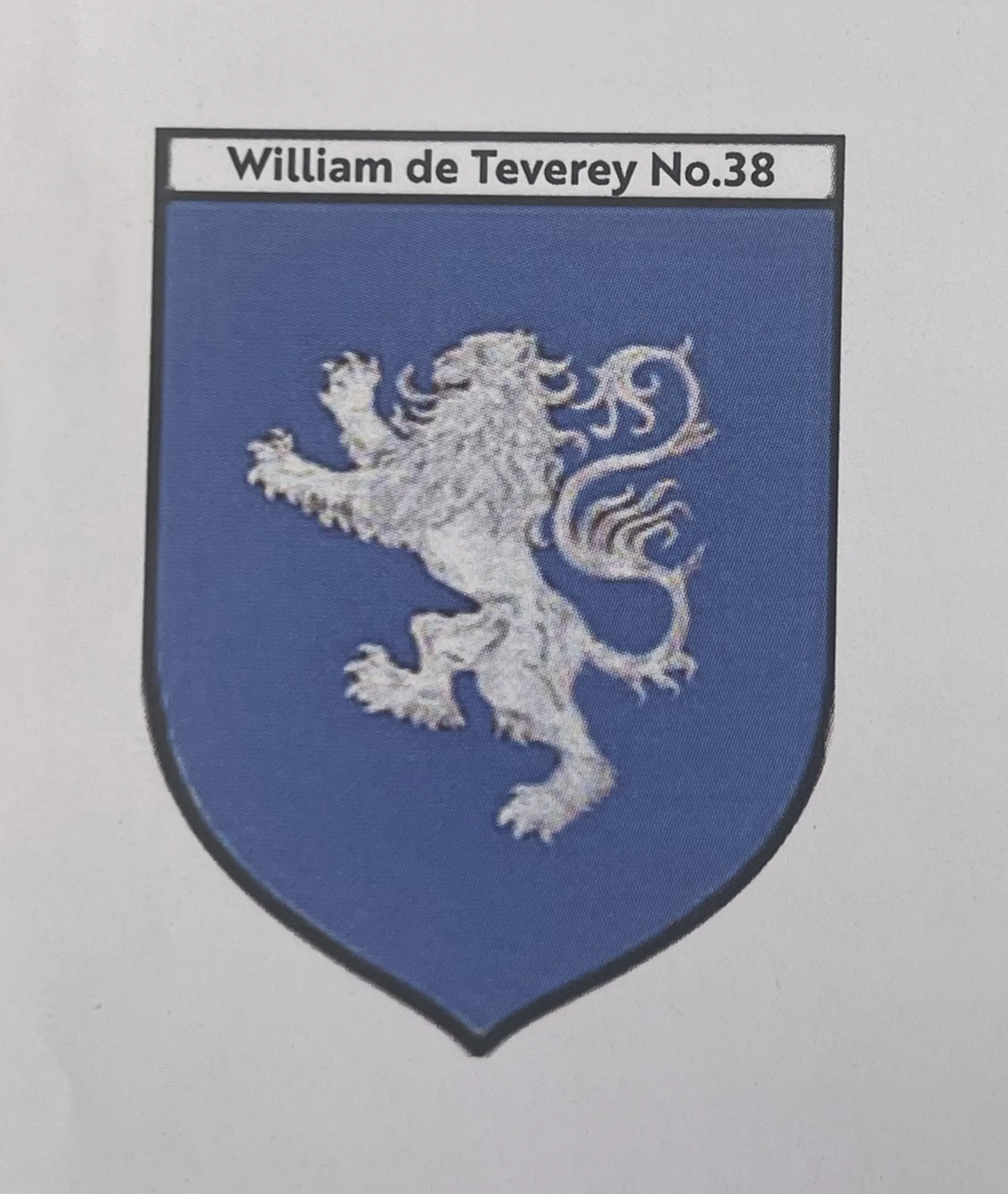 A heraldic shield with a blue background and a white lion passant facing left.