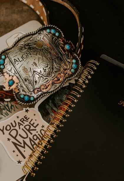 Western belt buckle and denim representing Anderson Aligned's rural Montana marketing focus