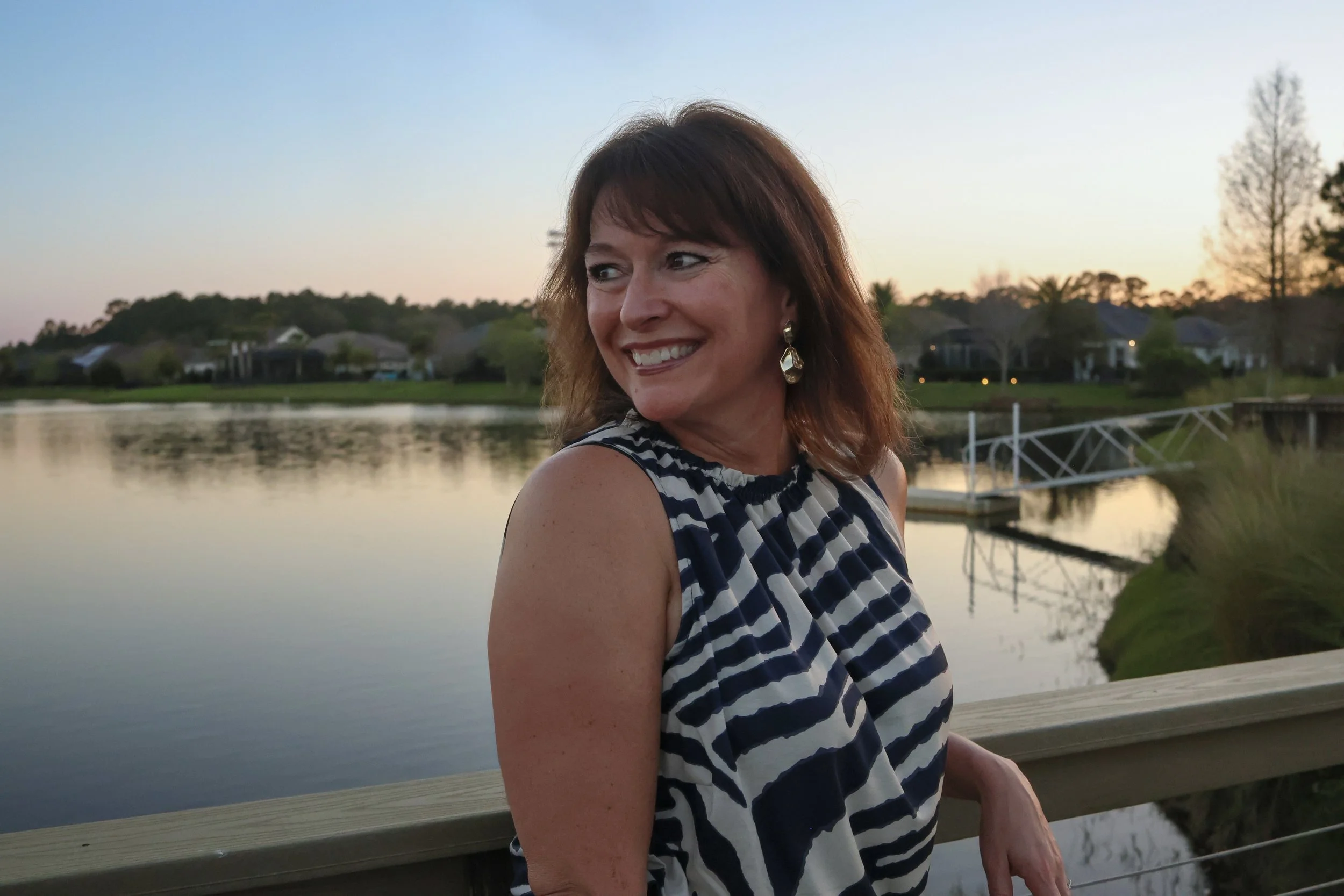 Karen Renaud, NBC-HWC and founder of inSPIREd Integrative Health, outdoors by the water.