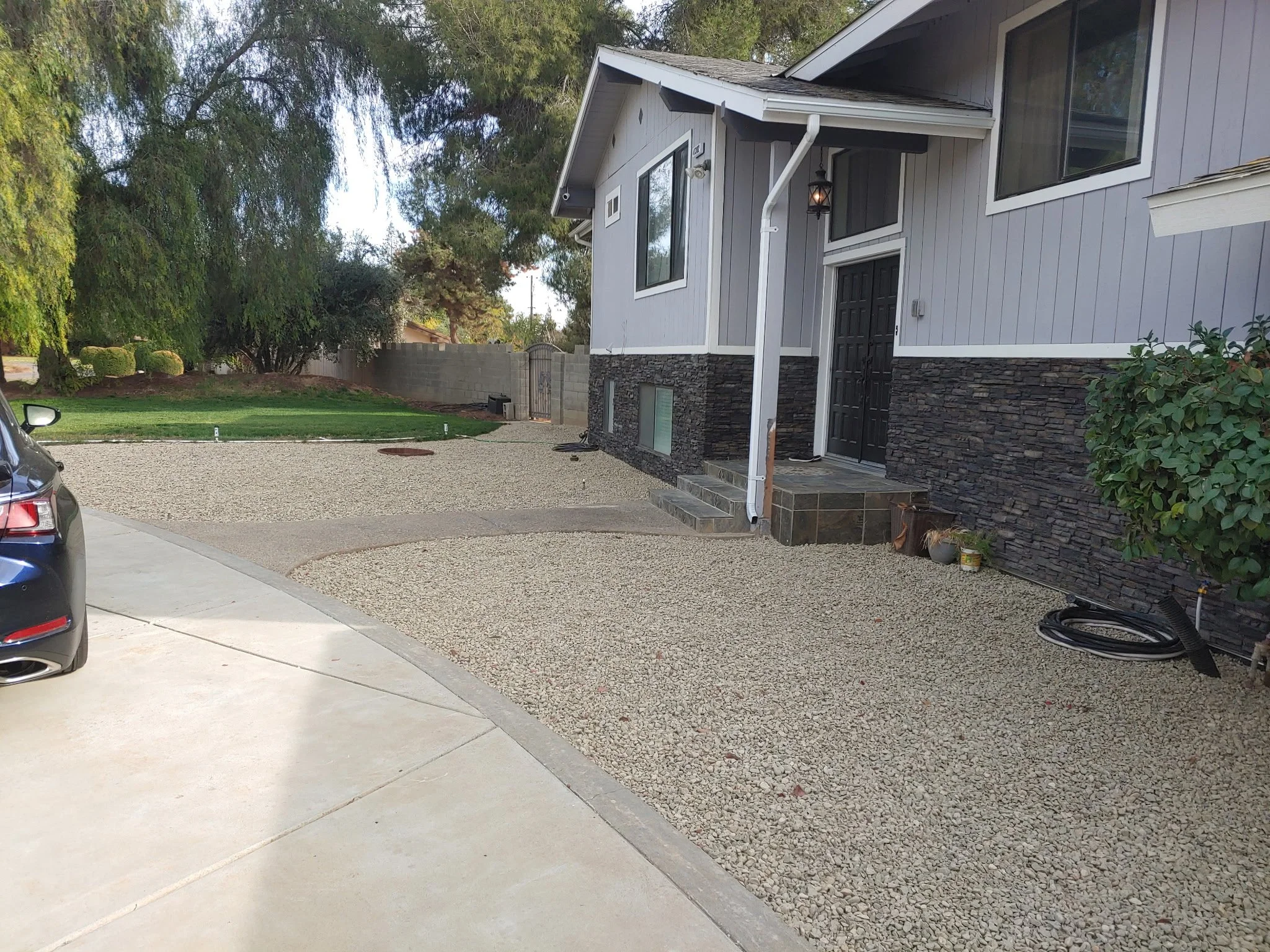 Exterior Rock Paneling and Gravel Landscape