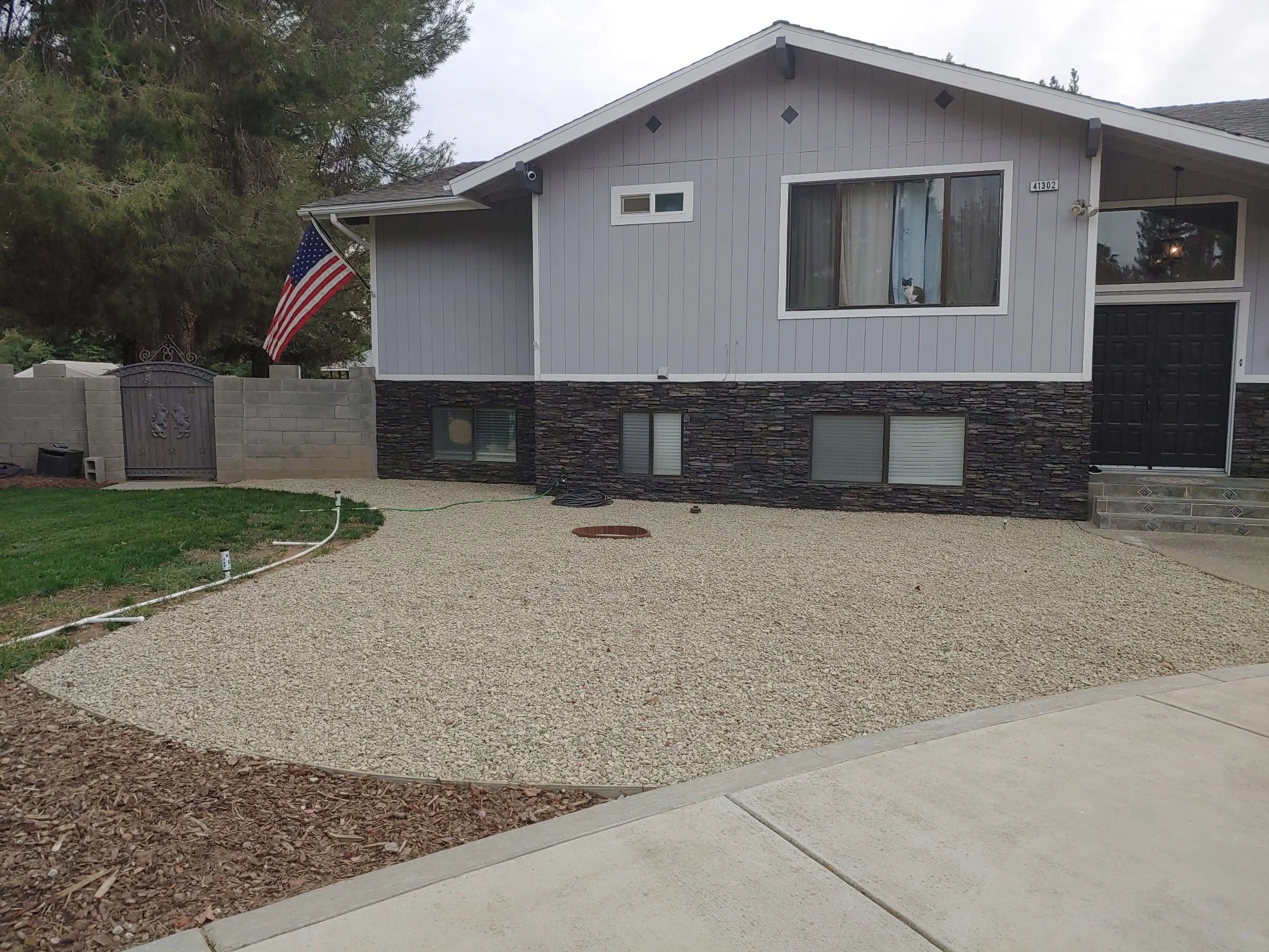 Exterior Rock Paneling and Gravel Landscape