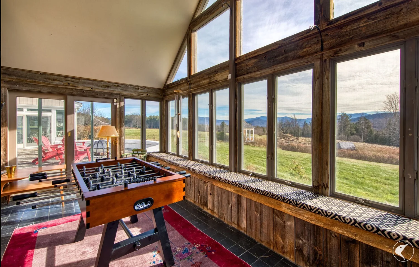 A custom sunroom addition built with hand crafted fir beams, slate floors and hand built trim details