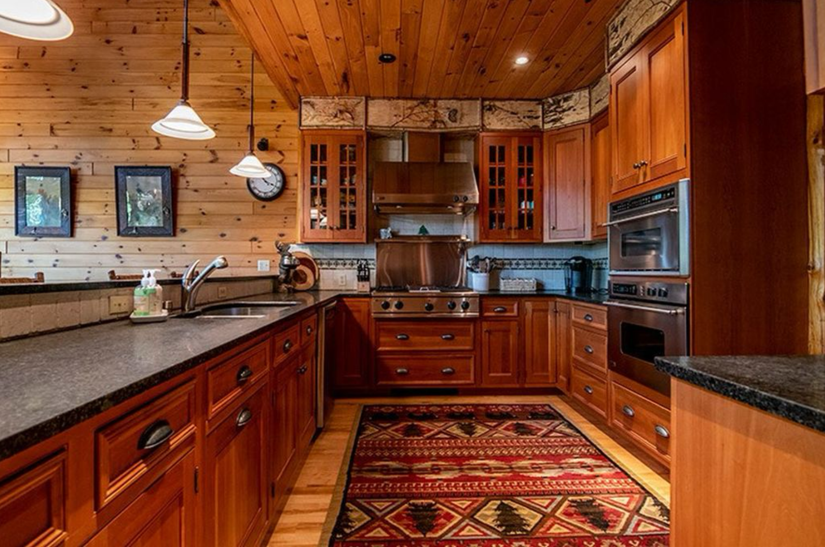 A custom kitchen with an adirondack theme using cherry, birch bark, cedar and maple