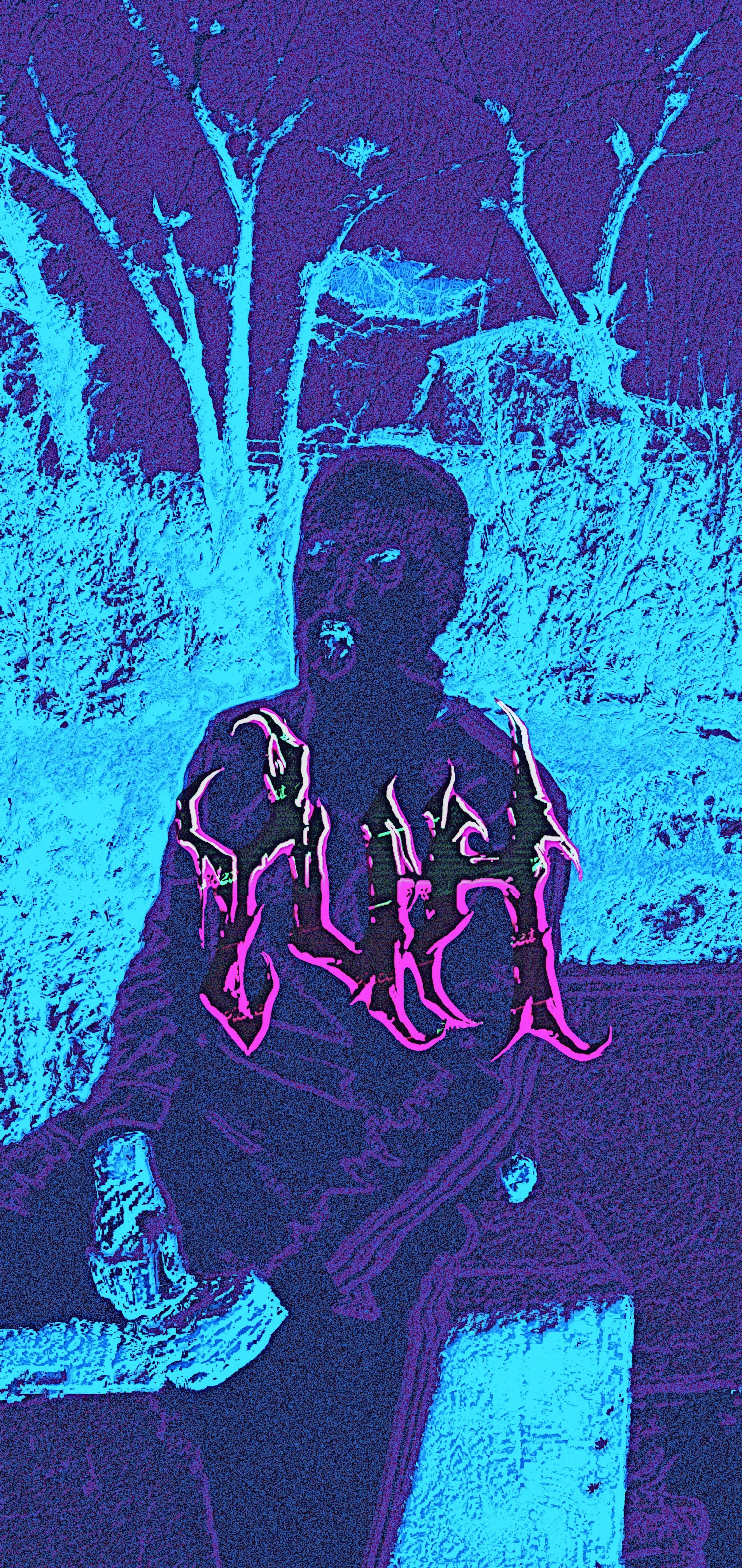 A person sitting on a bench outdoors at night, with bare trees in the background. The image has a stylized, high-contrast color effect.