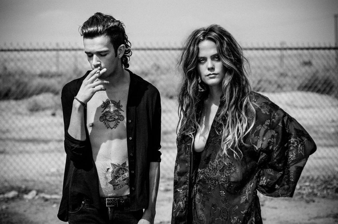 Black and white photo of Matty Healey singer of The 1975 and Chelsea Schuchman on the set of the music video for Robbers, photographed by tim mattia