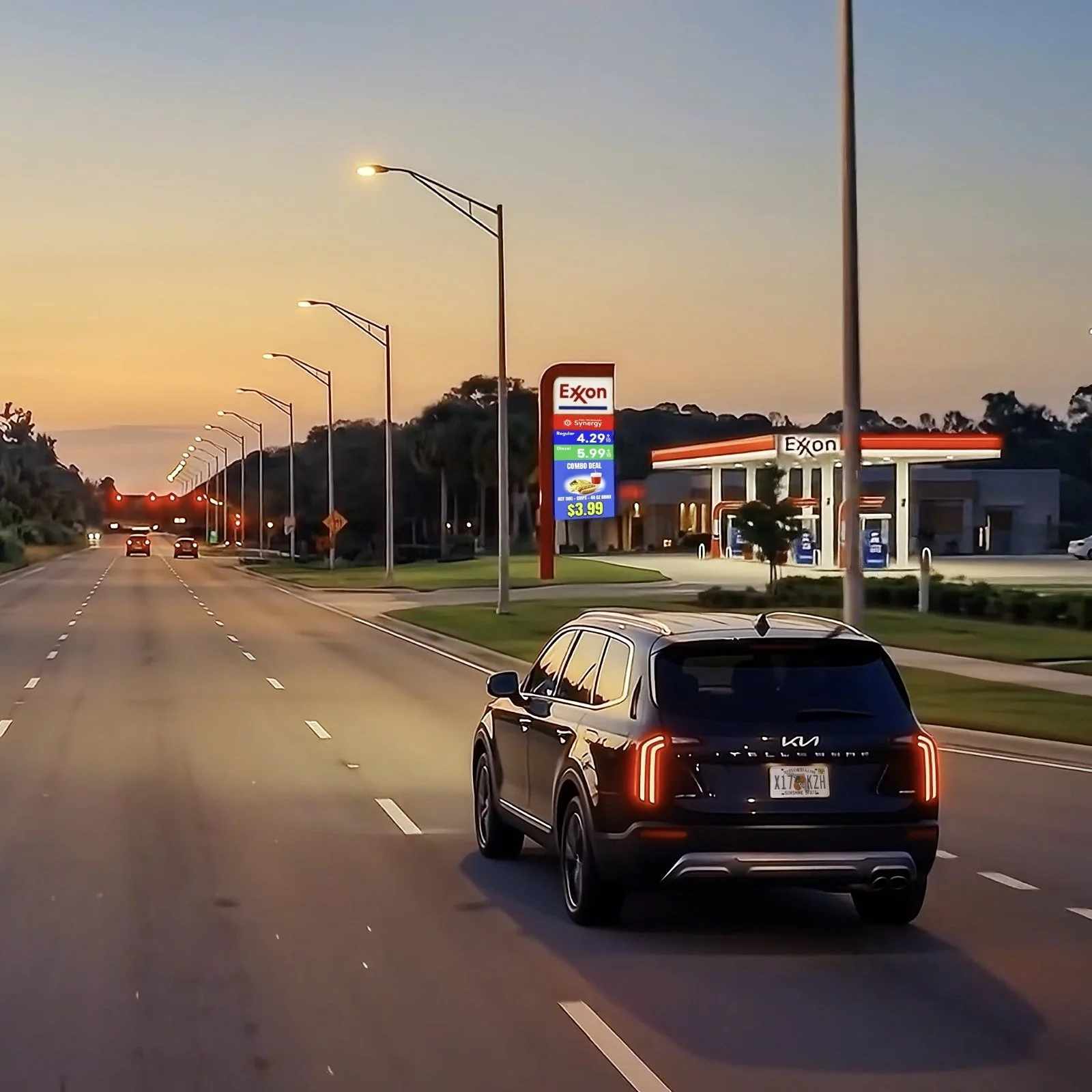 SUV on a highway at dusk heading toward a fuel station, frame from an AI-generated trade show video
