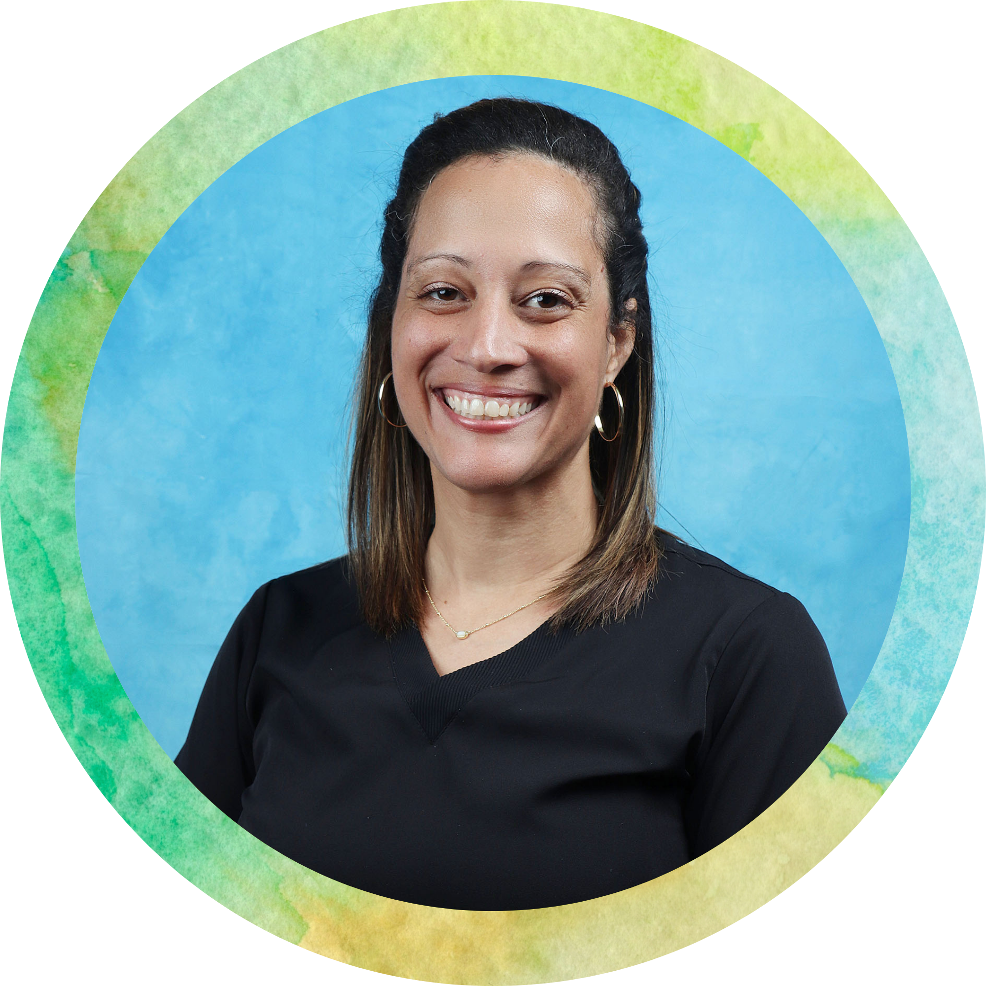 Smiling woman with long brown hair, wearing hoop earrings, a black top, and a delicate necklace, standing against a blue background with colorful watercolor-style circular overlay.