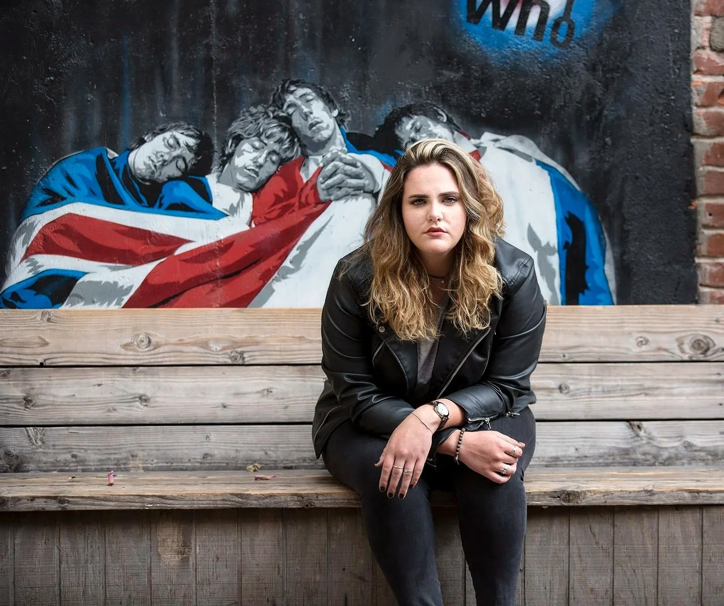 High school senior girl photographed in downtown San Luis Obispo in front of a mural of The Who.