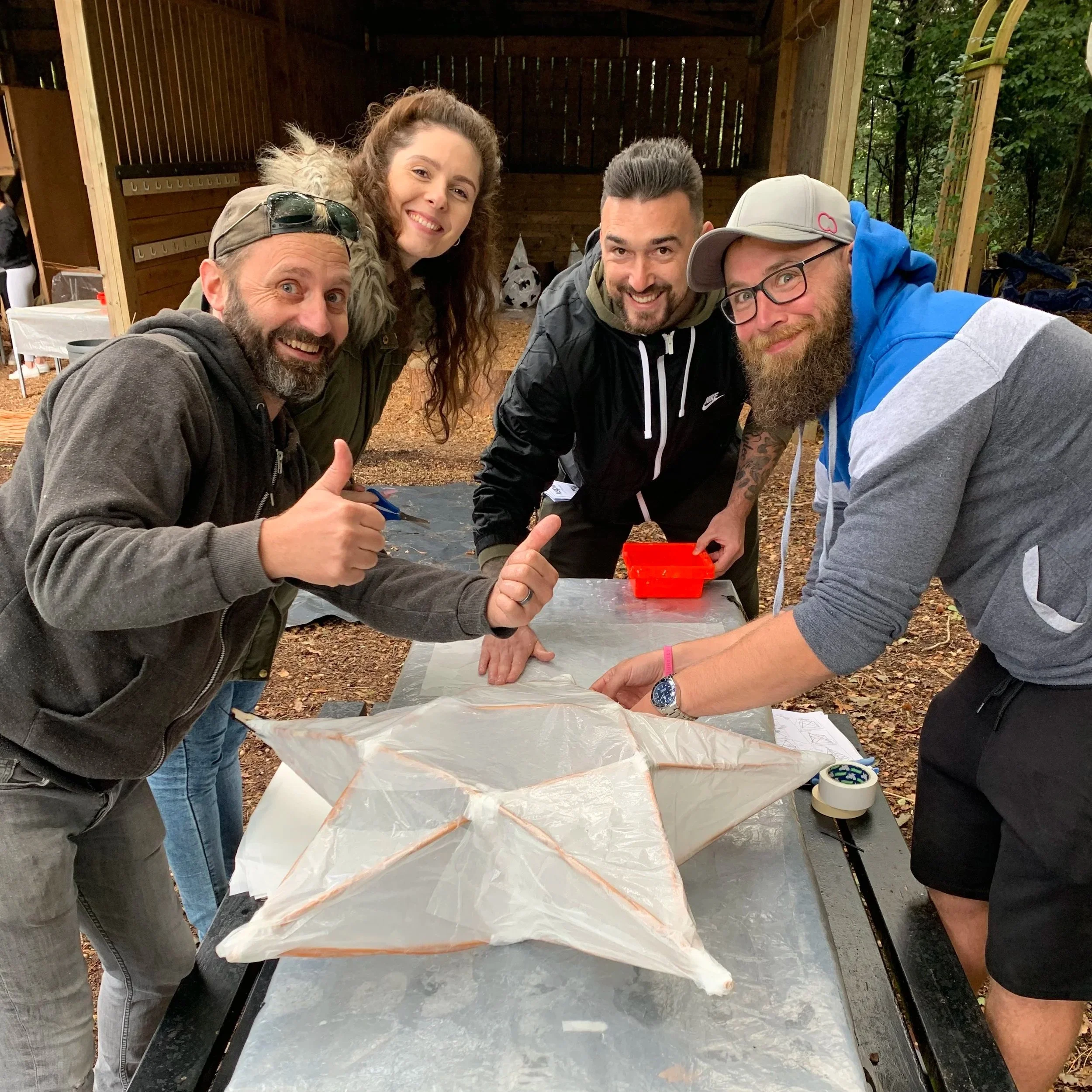 Group taking part in a hands-on corporate team-building art workshop with CreatingART in Wales.