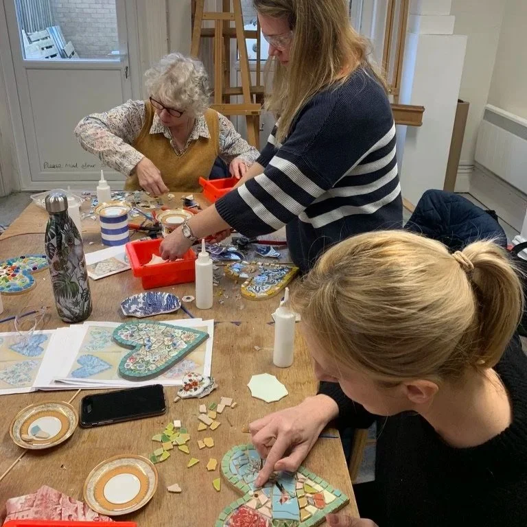 Adults taking part in a private group vintage china mosaic workshop with CreatingART in Wales.