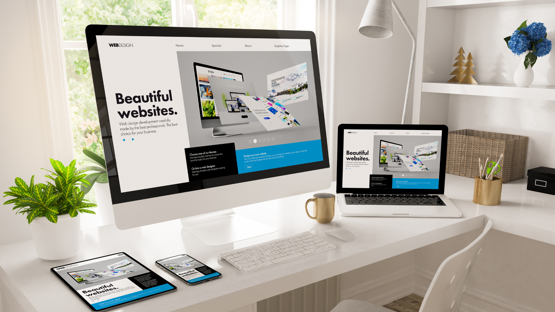 A modern white desk setup with a large iMac displaying a website template called 'Beautiful websites,' a MacBook laptop also showing the same website, an iPad, and an iPhone, all on a white desk in front of a window with greenery outside. The desk is decorated with a green plant, a white mug, a gold pencil holder, a black storage box, and a basket. A white wall shelf with blue flowers and gold decorative trees is visible in the background.