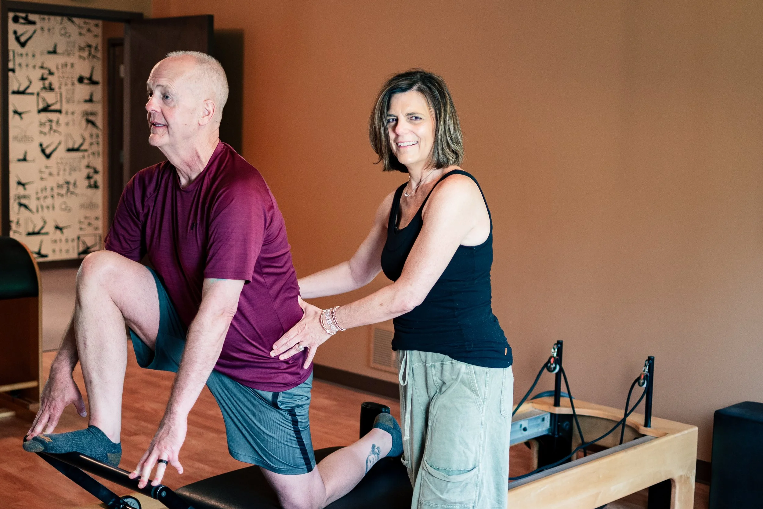 Rebecca Bell teaching Mike Stone a private pilates session at Mindful Movements in Fort Wayne, indian