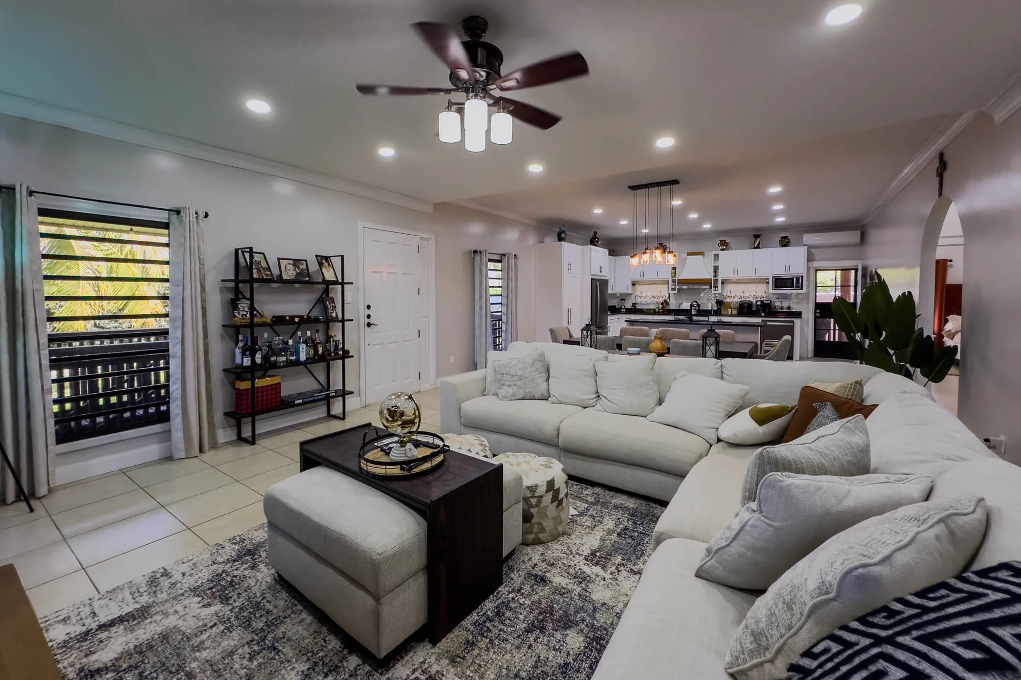 Open-plan living, dining and kitchen area inside Cayo Mountain View Estate, featuring spacious contemporary living areas and a modern kitchen.