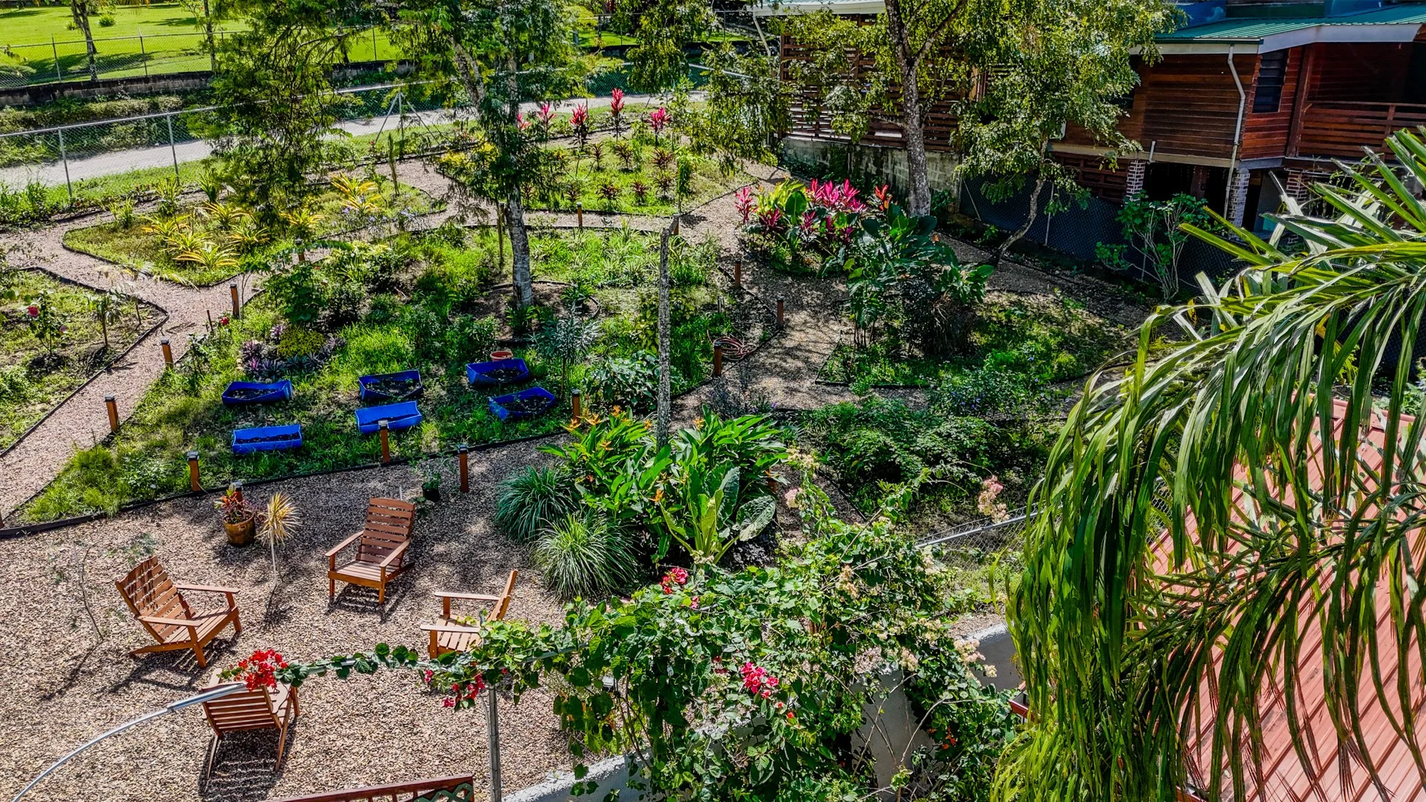 Landscaped Garden Property at Cayo Mountain View Estate, featuring winding pathways, tropical plants, flowering gardens and outdoor seating areas.