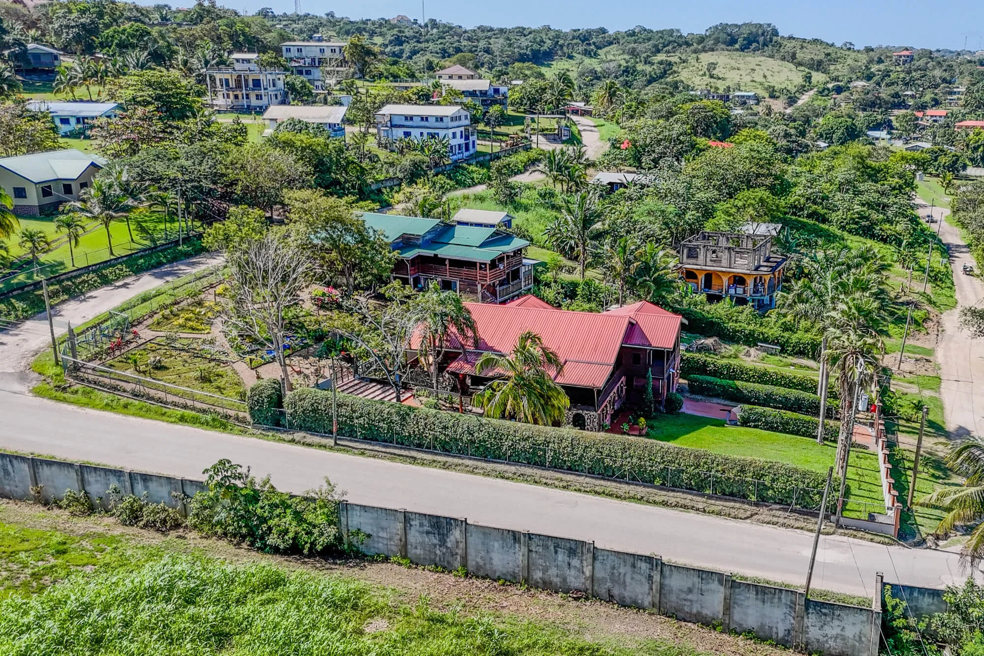 Aerial view of Santa Elena in Belize's Cayo District, showing the green residential surroundings of Cayo Mountain View Estate.