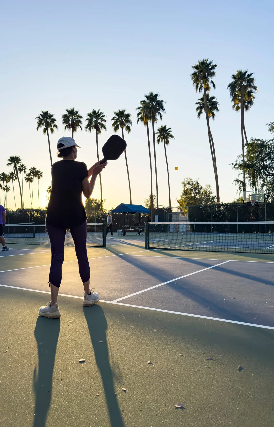 Women enjoying pickleball during a group getaway