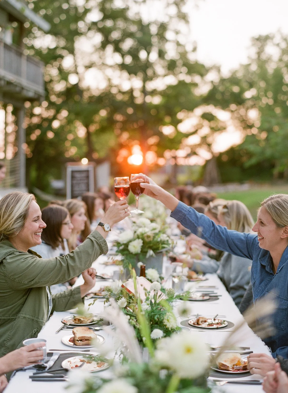 Women enjoying a private outdoor dinner during sunset during a girls getaway