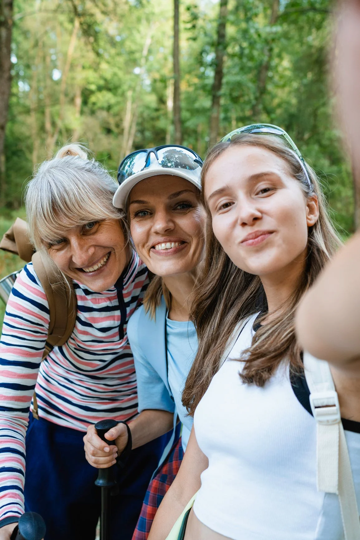 Three women taking a selfie outdoors while on a hike
