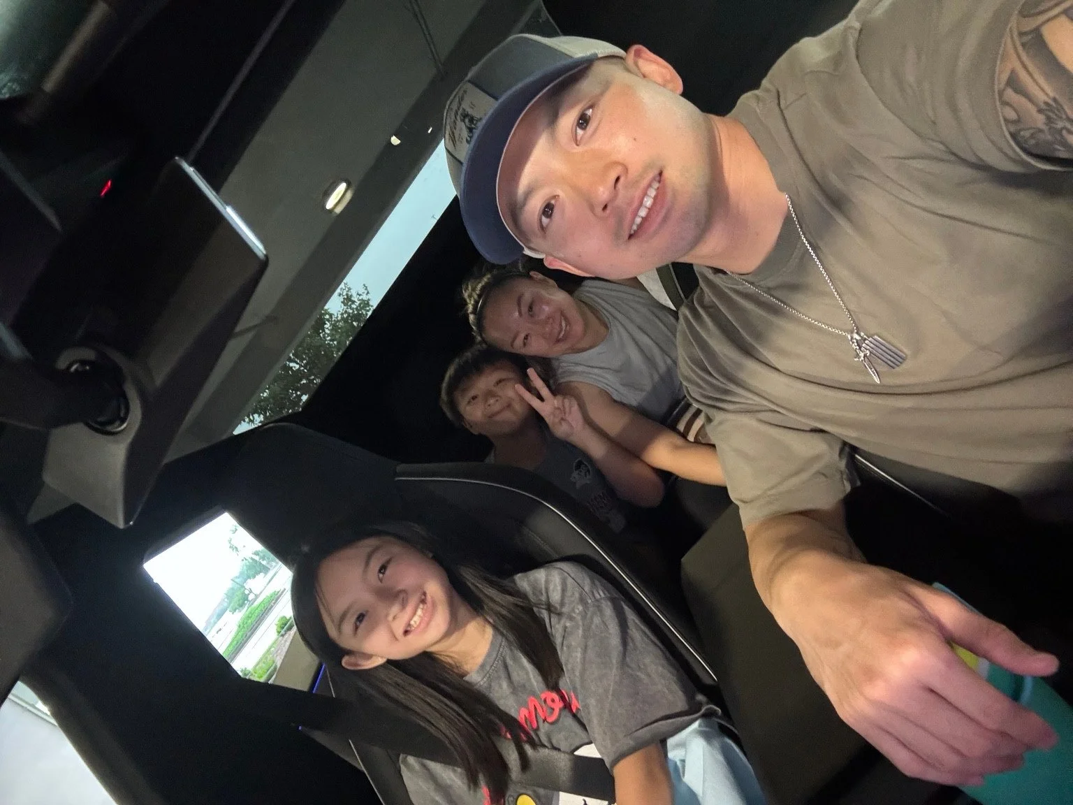 Ken and his family together in their car.