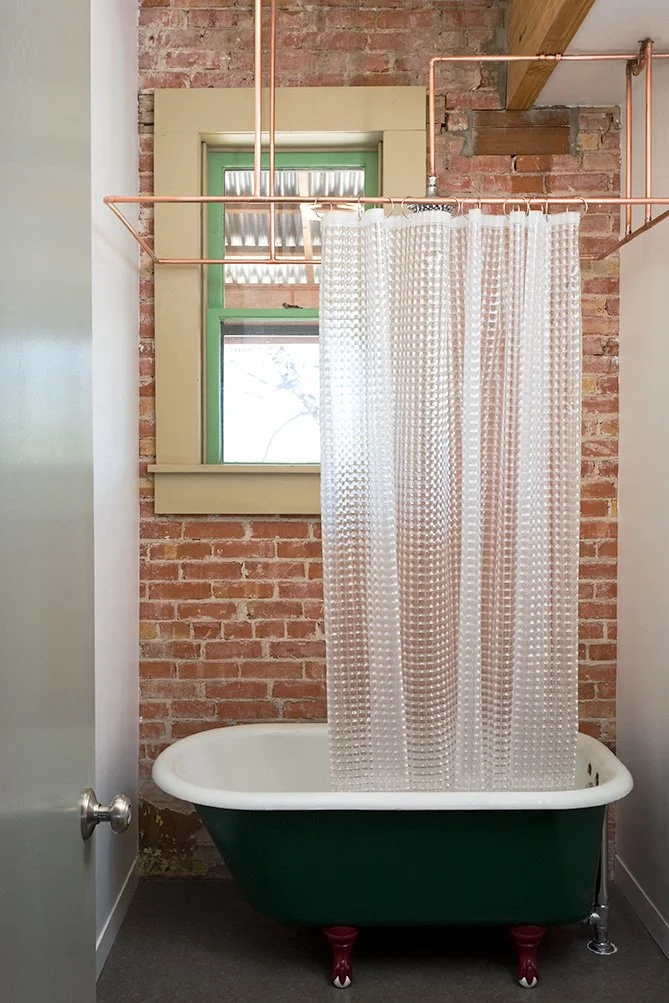 Rigid copper pipe shower curtain rod, vintage 1920’s cast-iron bath tub, residential loft, "El Picoso", San Antonio, Texas, 2008. Photo by Chris Cooper Photography
