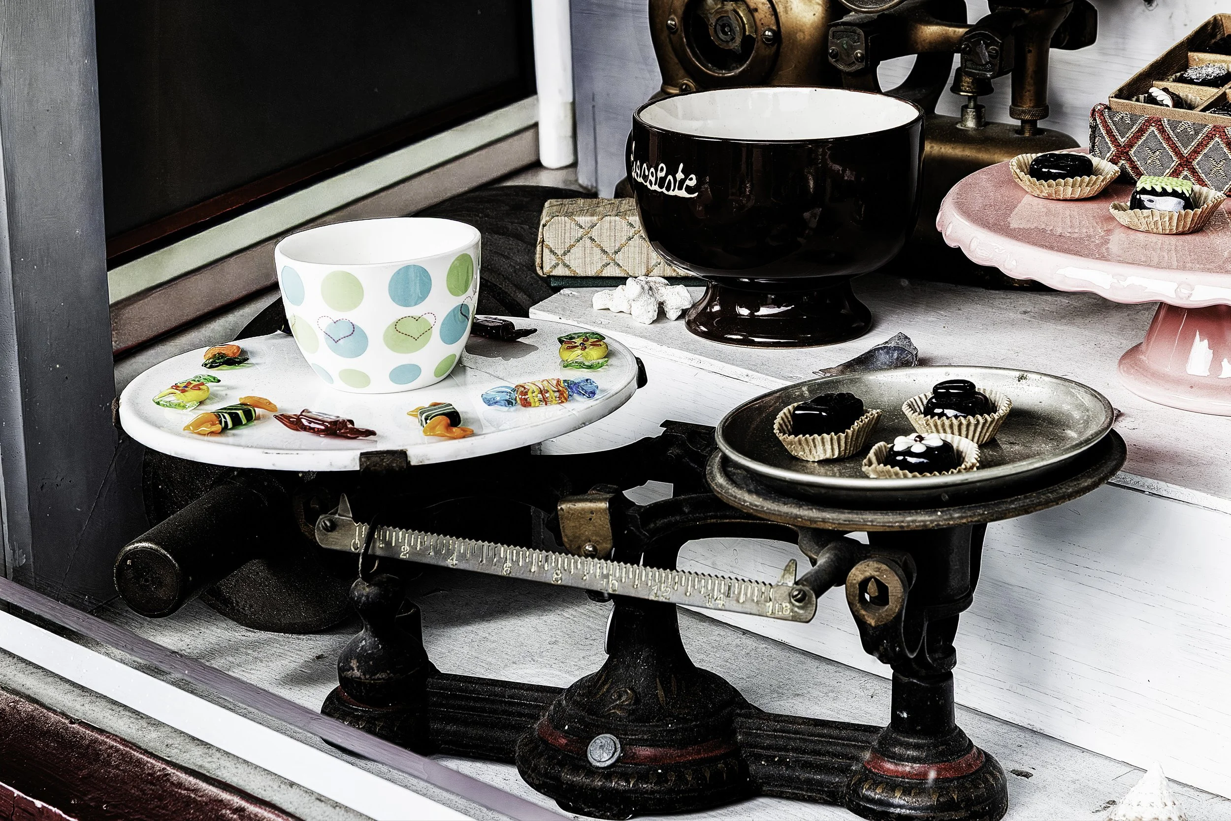 "Sweet Balance"- An old-fashioned scale holds colorful candies and chocolates, a playful contrast between weight and indulgence.