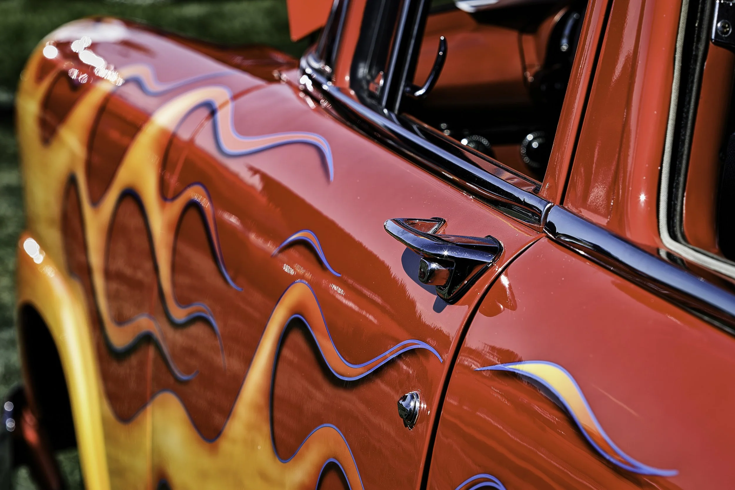 "Fire Brand"- Bold flames dance across gleaming red paint—an ode to classic hot rod craftsmanship and vintage American style.