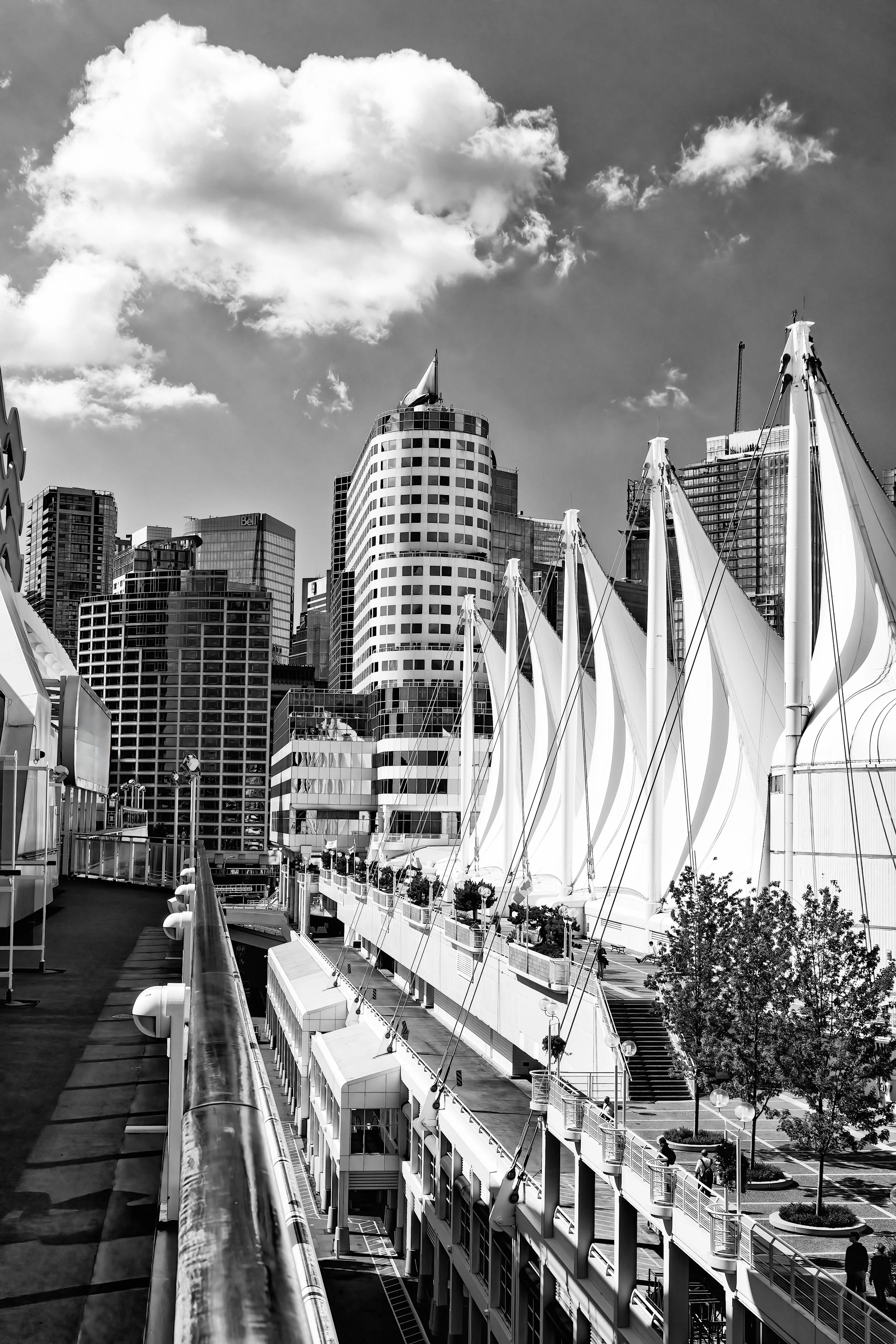 "Lines of Light – Canada Place and the Vancouver Skyline" - A black and white architectural study of Canada Place’s iconic sails and the surrounding Vancouver skyline, framed beneath dramatic coastal clouds.