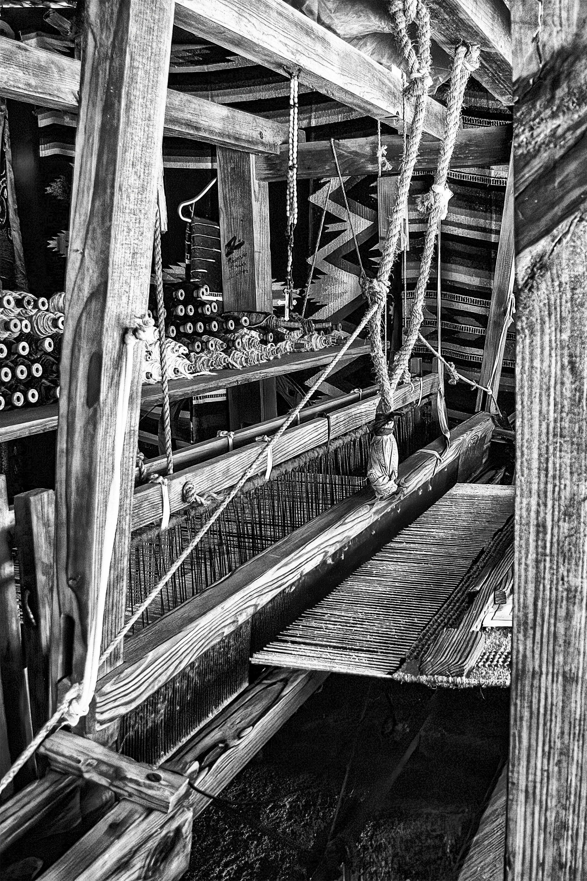"The Loom"- Close-up of a hand-operated wooden loom, showing heddles, warp threads, and reed. A classic setup used to make cloth in Mexico..