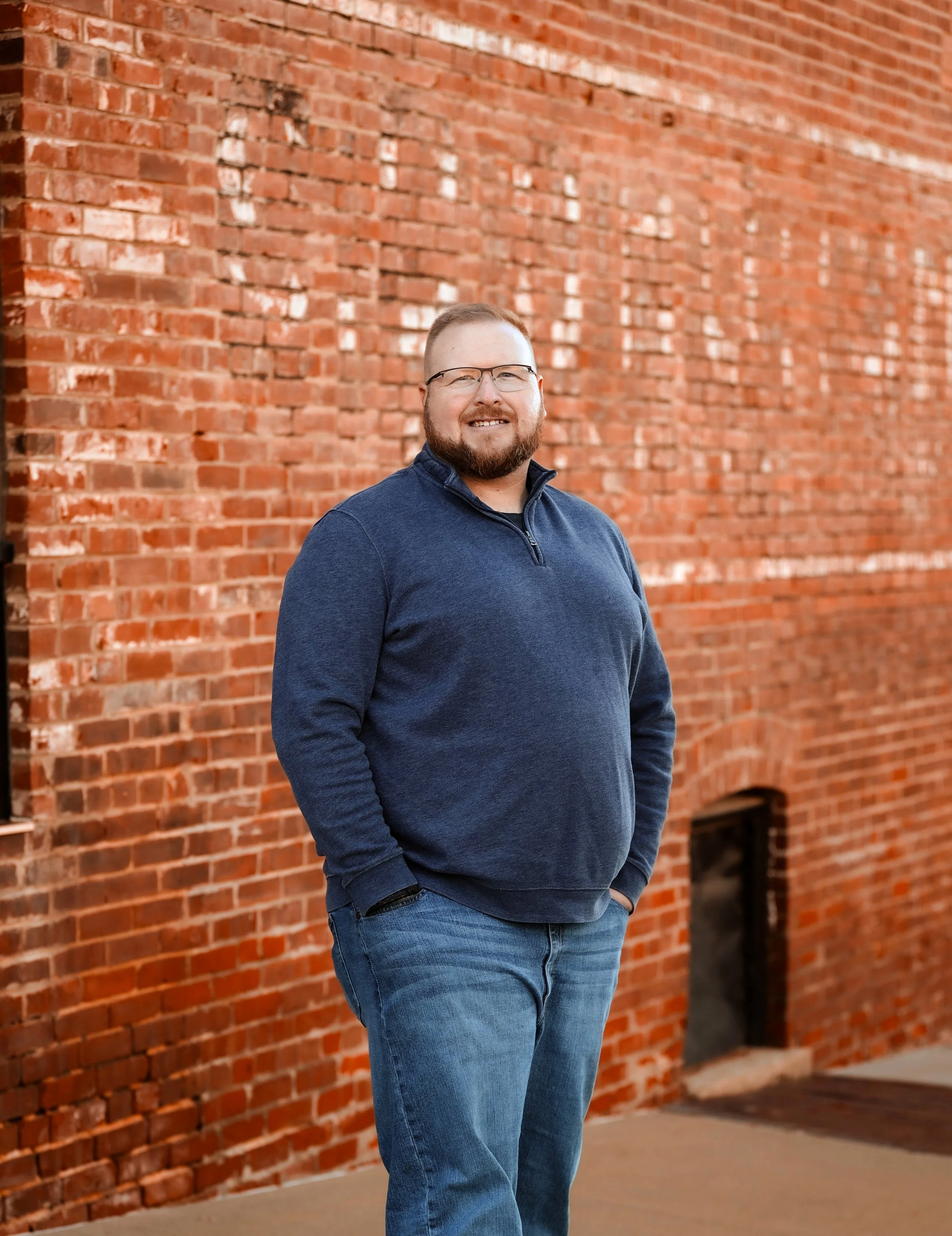 Ian Hobbs, LCSW, standing outside a brick building in Liberty, Missouri.