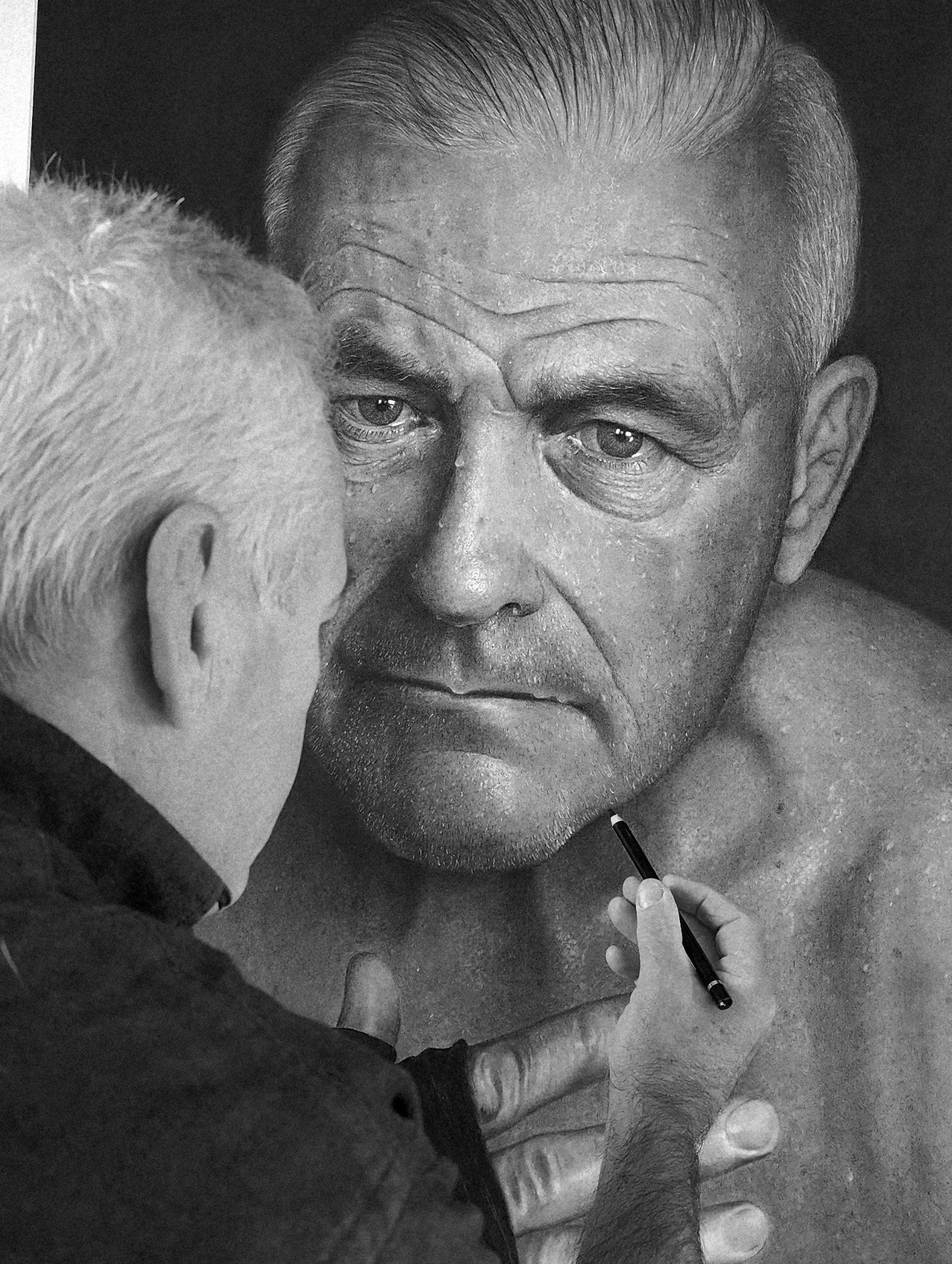 Black and white close-up photo of an elderly man with gray hair and wrinkles. Someone is applying makeup or a similar treatment to his face using a small brush, with the person's hand visible at the bottom of the image.