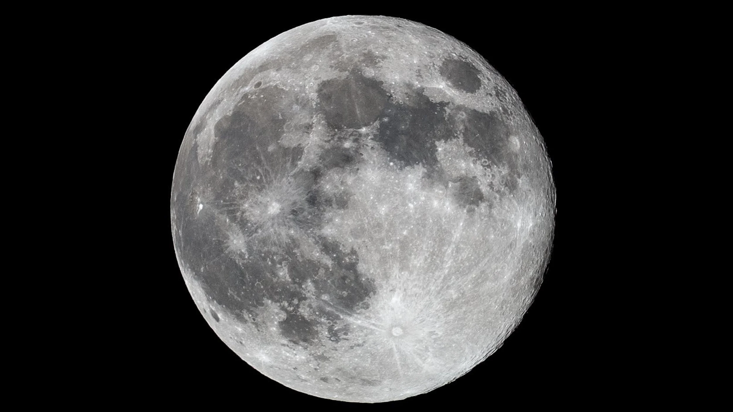 A detailed close-up view of the moon against a black sky.
