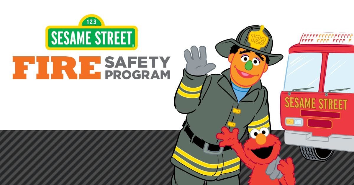 Illustration of Fire Safety Program featuring Sesame Street characters, including a firefighter and Elmo, with fire truck in the background.