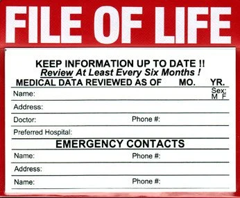 A red and white emergency file of life form with spaces for personal medical and emergency contact information, including name, address, doctor, phone number, and preferred hospital.
