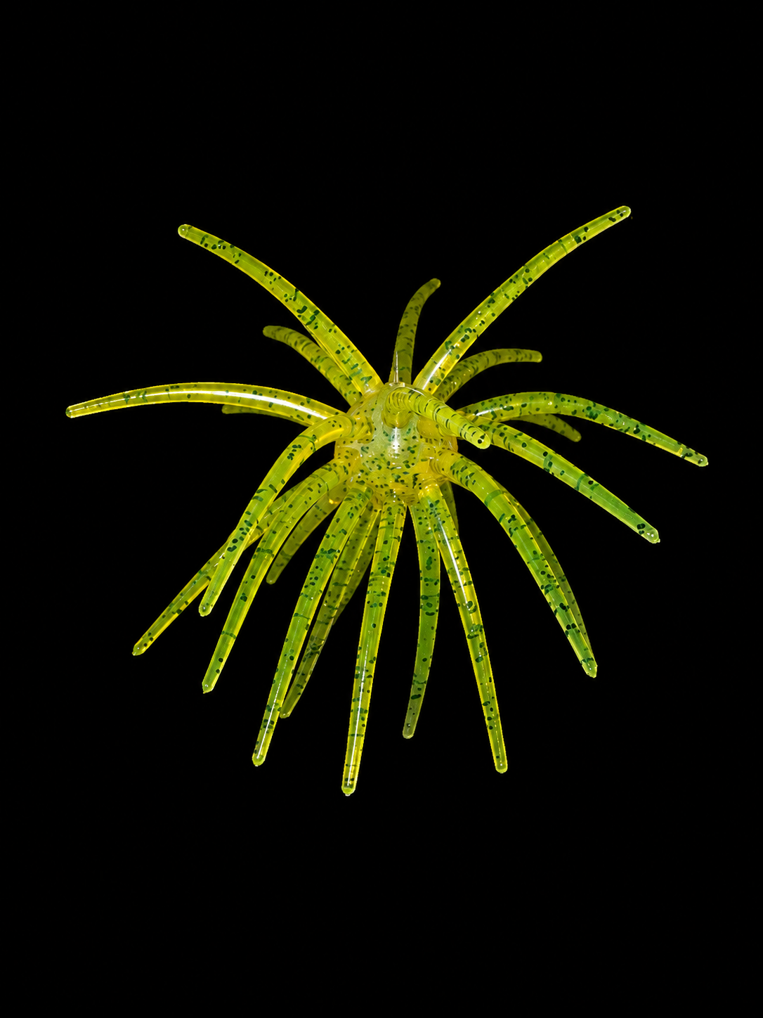 Yellow and green custom fishing Urchin lure on a black background.