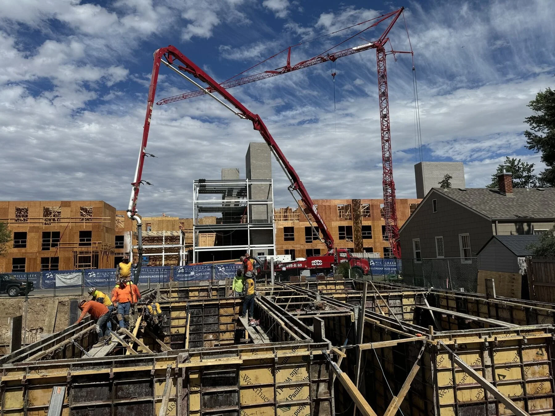 BSCS Pumping 38-meter boom pump reaching over forms on a commercial concrete pour