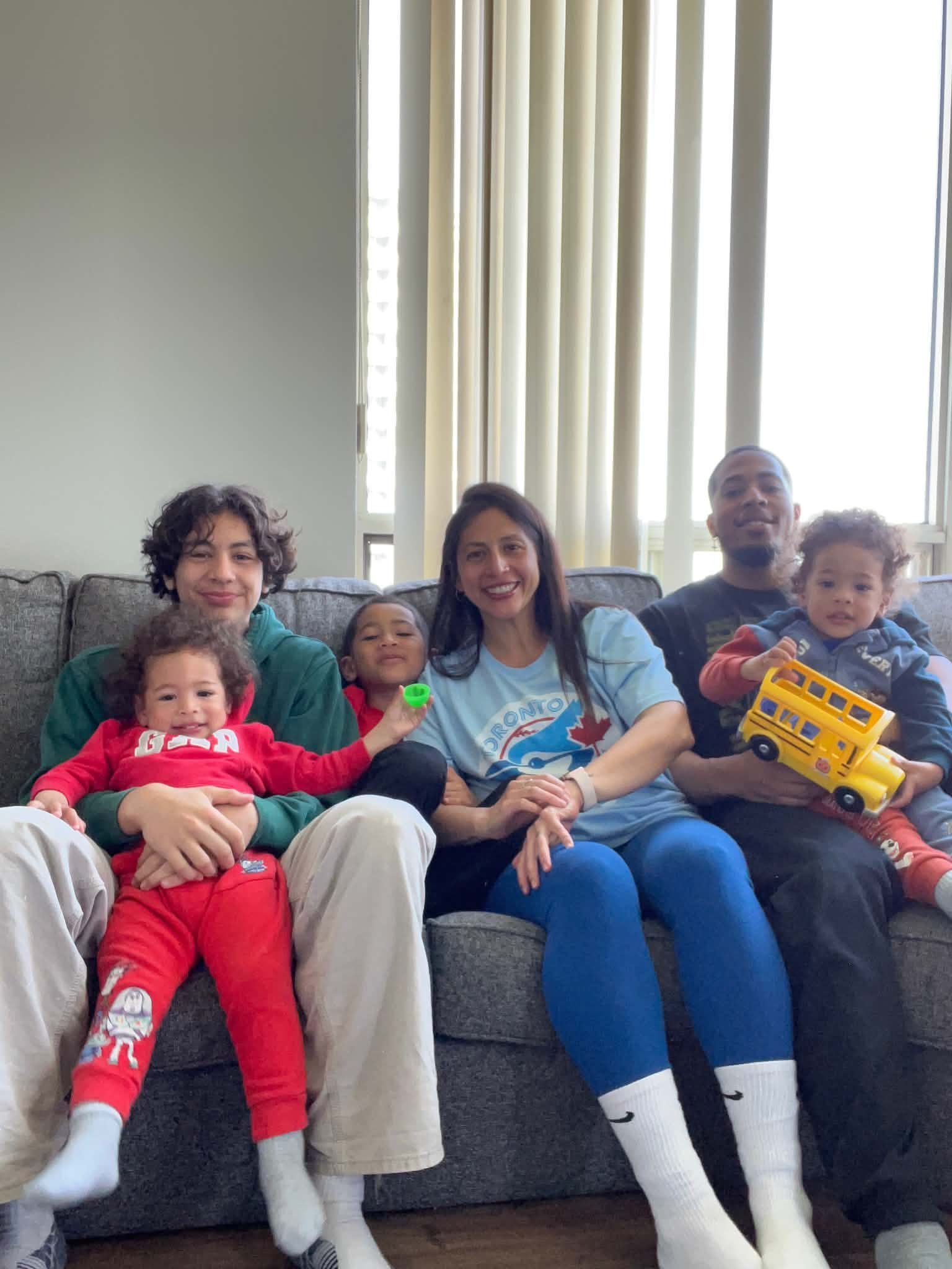 Rosanna Araujo with her family, smiling for a photo