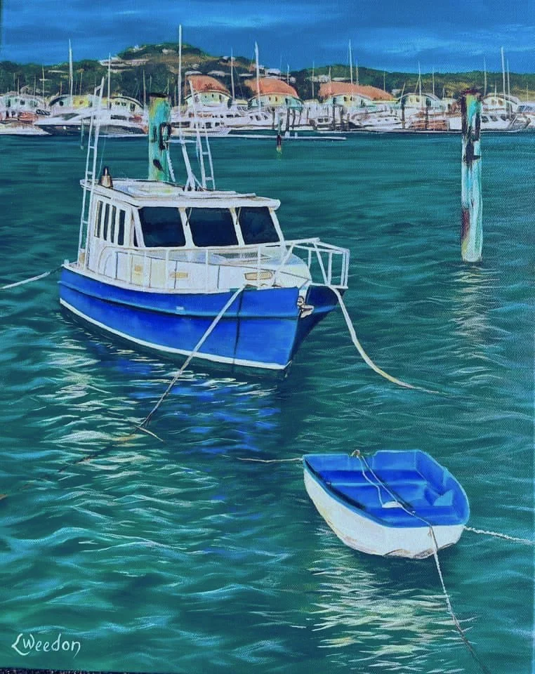 Painting of a blue and white motorboat and a small dinghy on calm harbor waters with a marina and buildings on a hillside in the background.